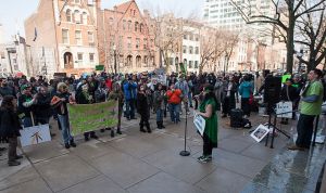 Vanessa Maria speaking to 350 demonstrators at the State House. (Picture from nj.com)