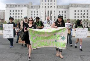 Jo Anne Zito and Vanessa Maria carrying the East Coast Cannabis Coalition banner from City Hall. (Photo from NJ.com)
